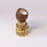 Coconut Shell Candle with Wooden Wick on Stacked Wood Base