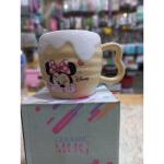 A uniquely designed porcelain mug in light beige with a raised embossed design