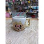 A uniquely designed porcelain mug in light beige with a raised embossed design