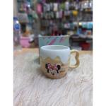 A uniquely designed porcelain mug in light beige with a raised embossed design