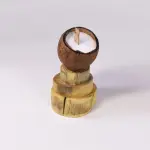 Coconut Shell Candle with Wooden Wick on Stacked Wood Base